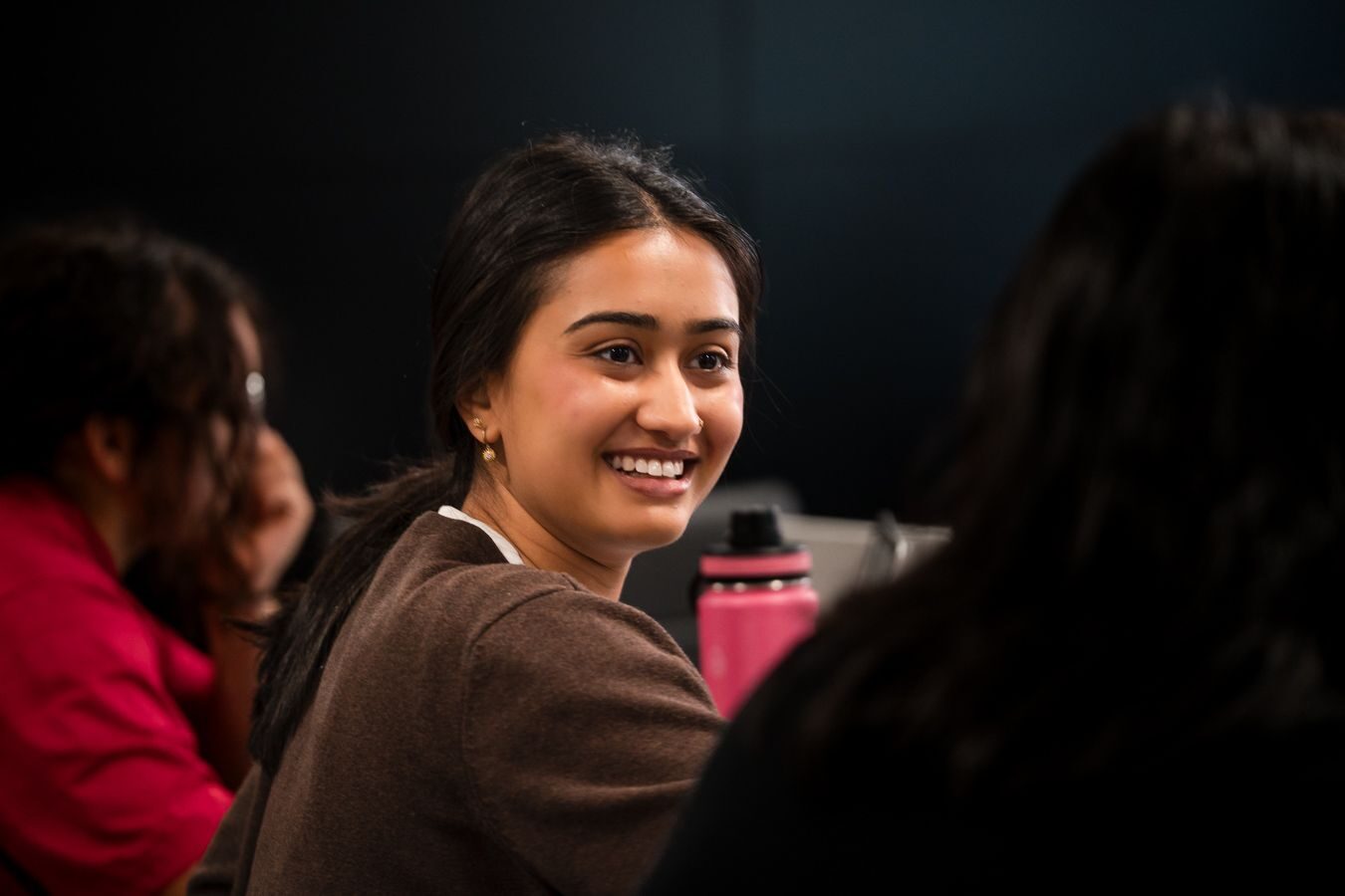 A team member smiling during a working session at the PhoenixTeam office